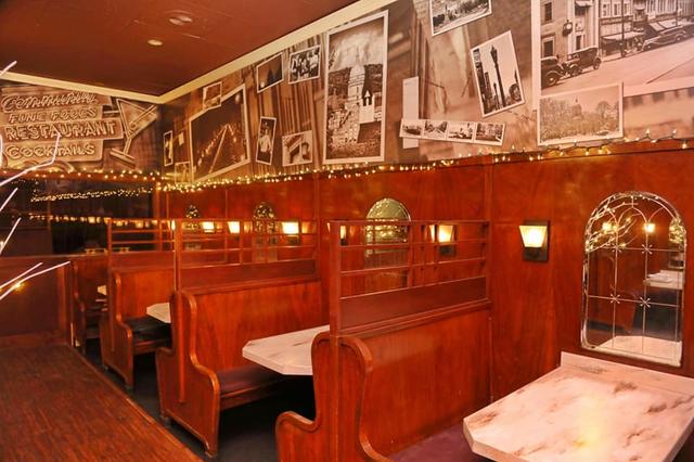 Wooden booths inside the Community Restaurant, black and white